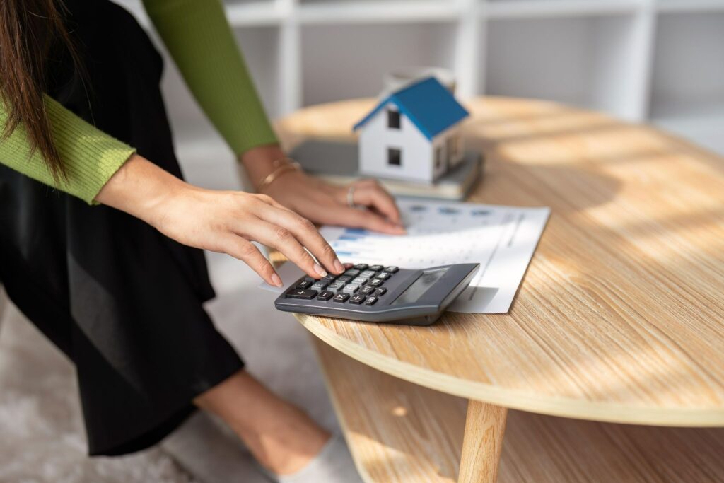 Woman uses calculator to calculate taxes.